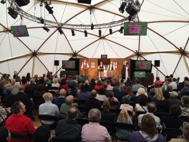 people performing on a stage to an audience