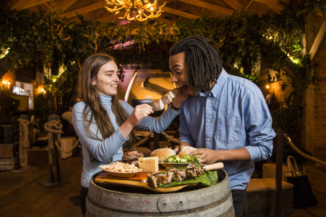 a woman feeding a man