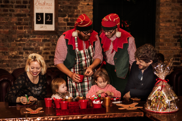 elves helping children decorate gingerbread men