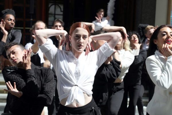 People performing in costume outside the Palladium