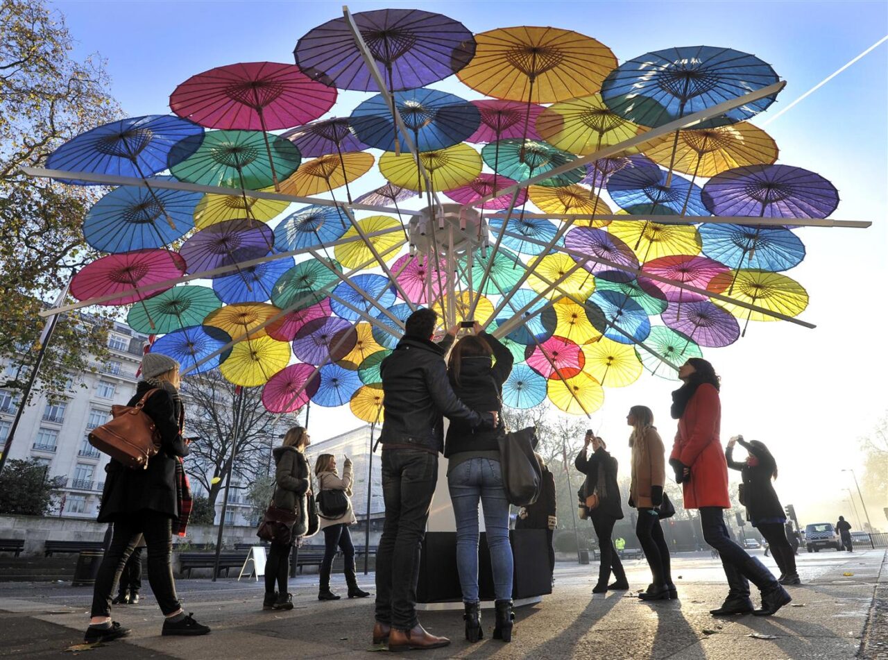 people taking photos of the umbrellas