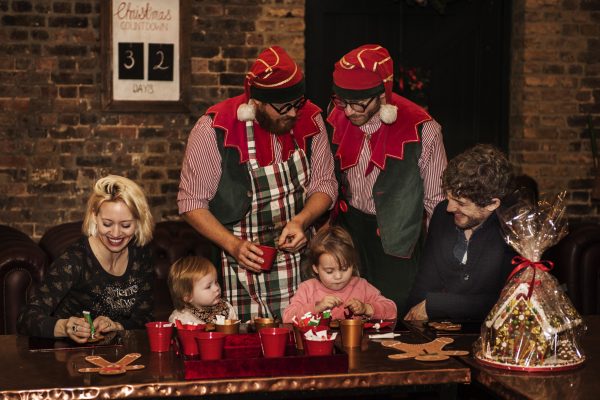 elves helping children decorate gingerbread men