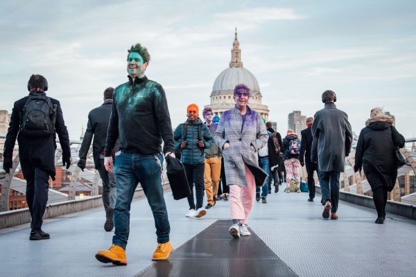 People walking with coloured paint on them