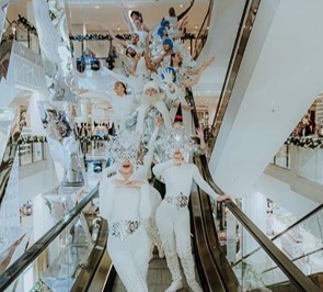 people dressed up on an escalator