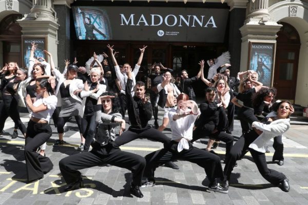 People performing in costume outside the Palladium