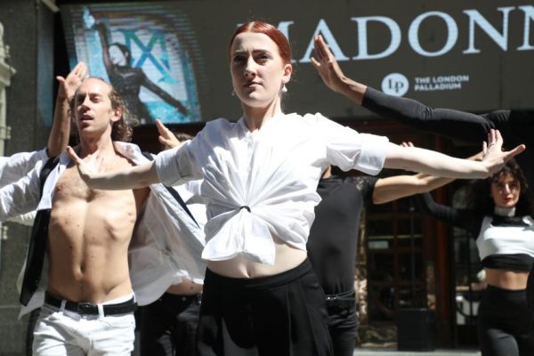 People performing in costume outside the Palladium