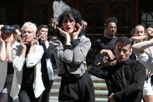 People performing in costume outside the Palladium