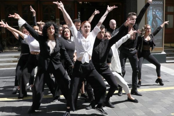 People performing in costume outside the Palladium